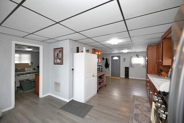 69465 High St, Union, MI 49130 - kitchen featuring range with gas cooktop, a paneled ceiling, light wood finished floors, and baseboards