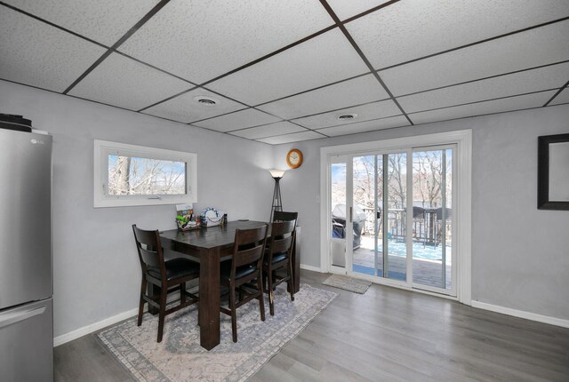 69465 High St, Union, MI 49130 - dining room with a paneled ceiling, wood finished floors, and baseboards