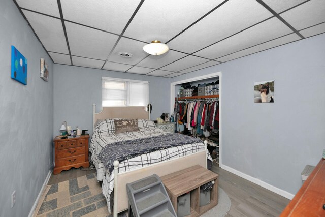 69465 High St, Union, MI 49130 - bedroom featuring a paneled ceiling, wood finished floors, baseboards, and a closet