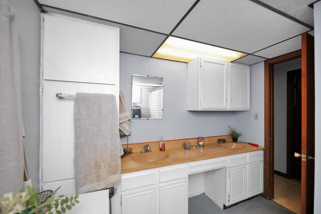 69465 High St, Union, MI 49130 - kitchen featuring a sink, white cabinets, light countertops, and a drop ceiling