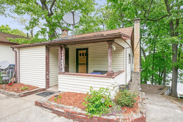69465 High St, Union, MI 49130 - view of front of property with a chimney and covered porch