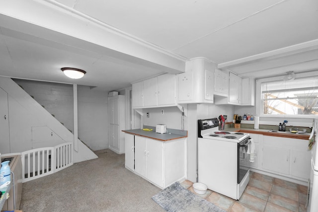69465 High St, Union, MI 49130 - kitchen with white range with electric cooktop, white cabinetry, and a sink