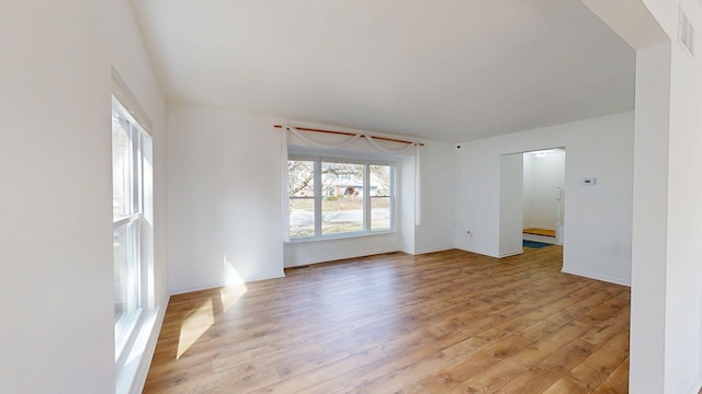 unfurnished room featuring visible vents and light wood finished floors