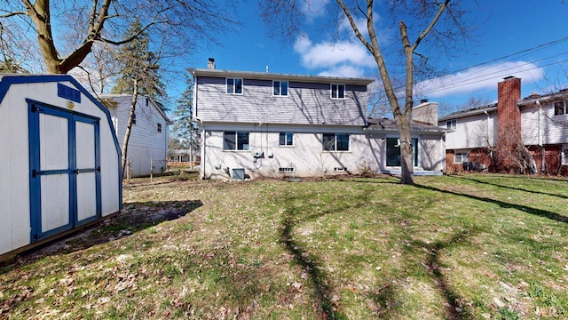 rear view of house with a storage shed, an outdoor structure, and a lawn