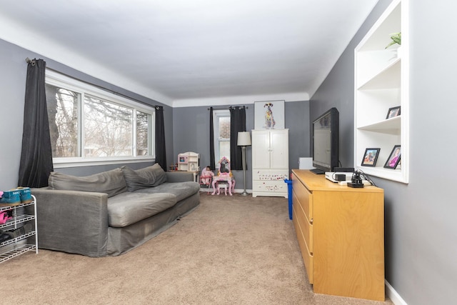 carpeted living room with baseboards