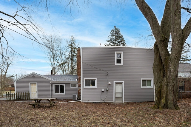 rear view of property featuring fence