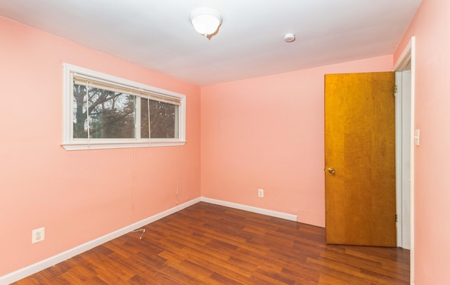 unfurnished room with wood finished floors and baseboards