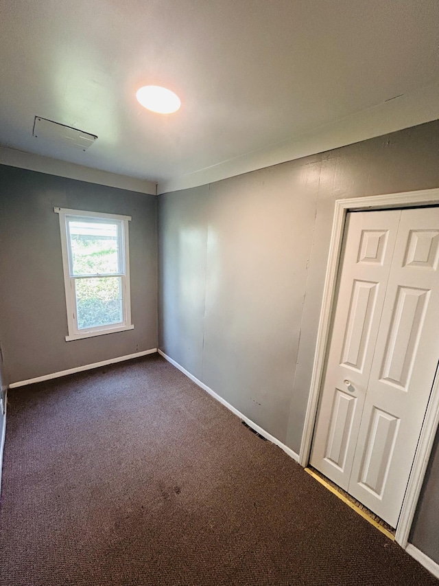 509 Mccourtie St, Kalamazoo, MI 49008 - empty room with dark colored carpet and baseboards