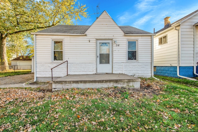 bungalow-style home with fence
