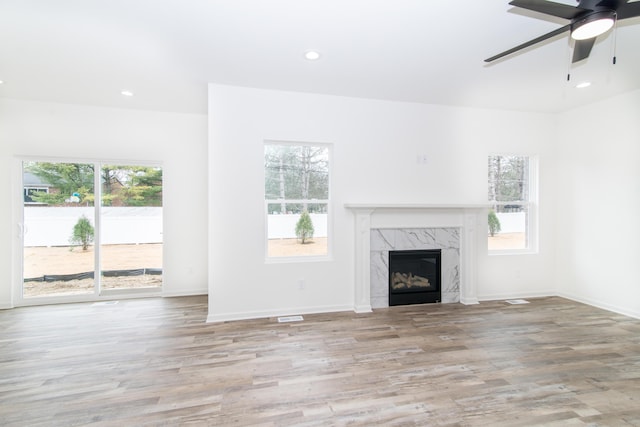 20233 Sunset Ave, Livonia, MI 48152 - unfurnished living room with ceiling fan, recessed lighting, a premium fireplace, and wood finished floors