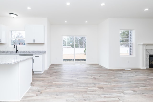 20233 Sunset Ave, Livonia, MI 48152 - kitchen featuring open floor plan, light stone countertops, and recessed lighting