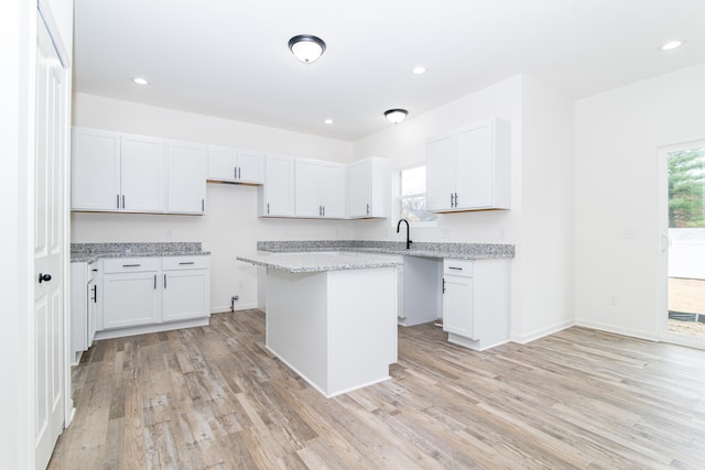 20233 Sunset Ave, Livonia, MI 48152 - kitchen with plenty of natural light, light wood-style flooring, a center island, and white cabinetry