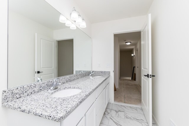 20233 Sunset Ave, Livonia, MI 48152 - bathroom with baseboards, double vanity, marble finish floor, and a sink