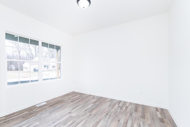 20233 Sunset Ave, Livonia, MI 48152 - spare room featuring visible vents, baseboards, and wood finished floors