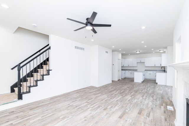 20233 Sunset Ave, Livonia, MI 48152 - unfurnished living room with recessed lighting, a ceiling fan, light wood-style floors, visible vents, and a sink