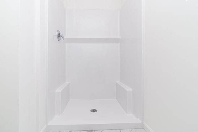 20233 Sunset Ave, Livonia, MI 48152 - bathroom featuring a stall shower and baseboards