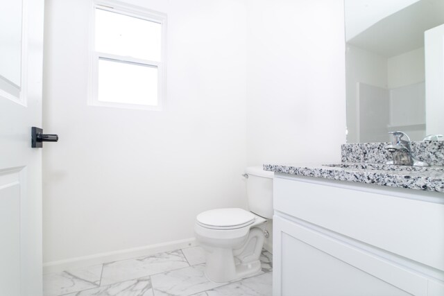 20233 Sunset Ave, Livonia, MI 48152 - bathroom with toilet, baseboards, marble finish floor, and vanity