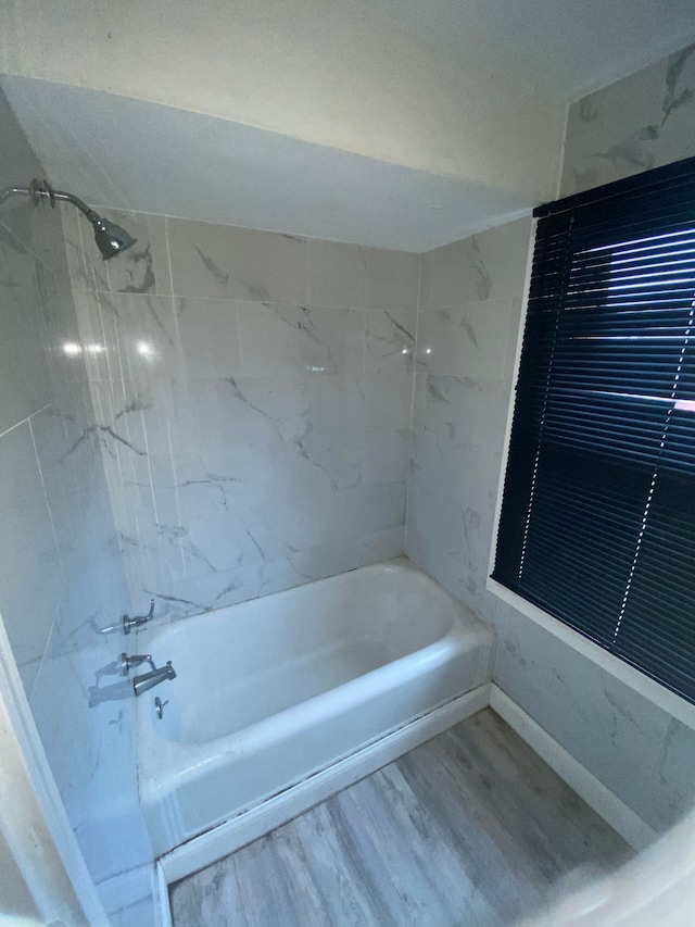 full bathroom featuring bathing tub / shower combination and wood finished floors