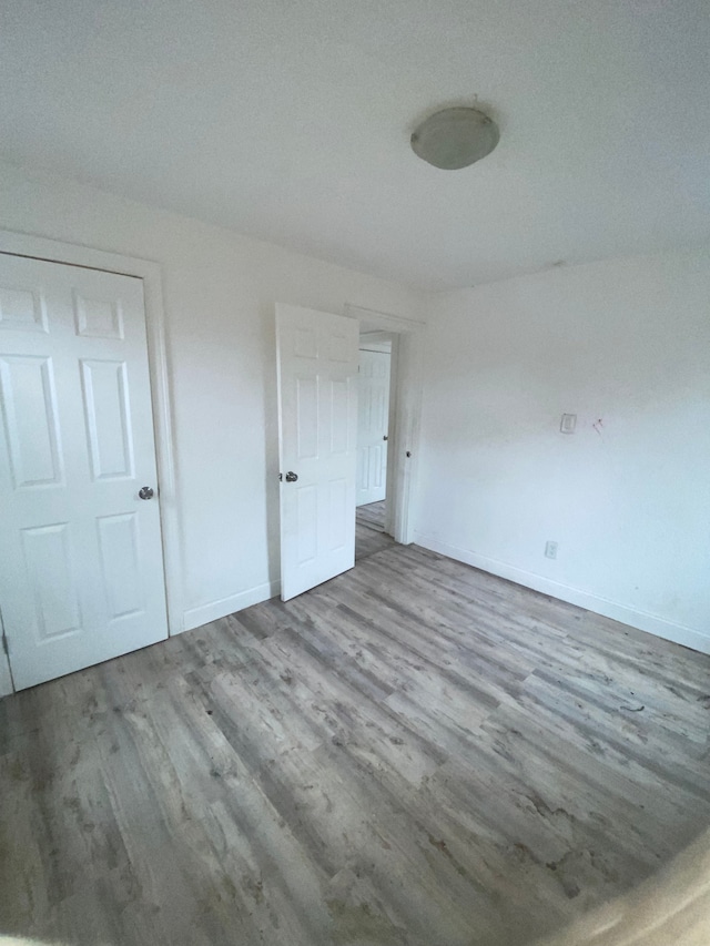 interior space with baseboards and wood finished floors