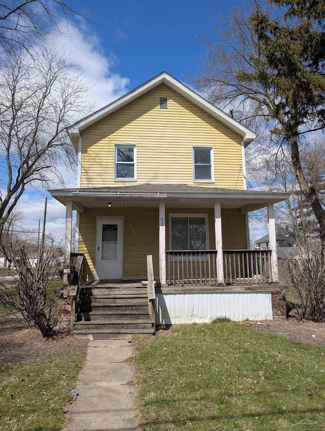 921 S Fayette St, Saginaw, MI 48602 - view of front of home with covered porch and a front yard