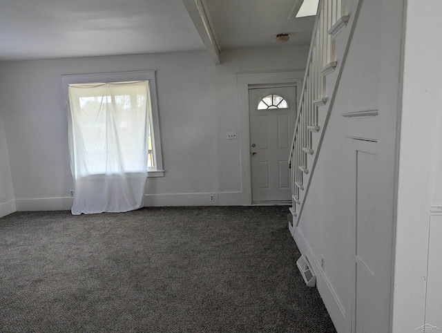 921 S Fayette St, Saginaw, MI 48602 - entryway with dark colored carpet, beam ceiling, visible vents, and stairs