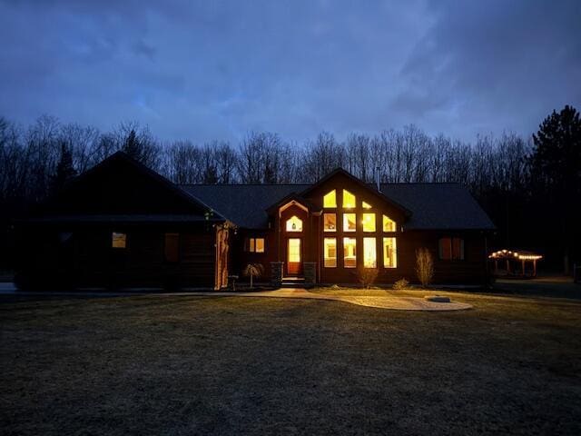 rear view of property featuring a yard