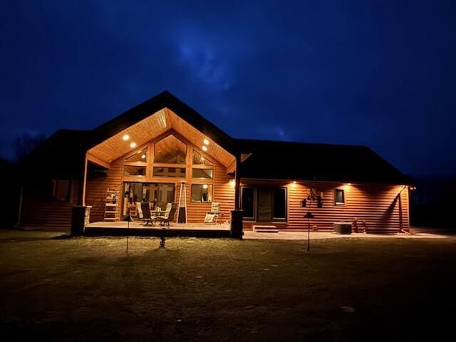 back of house at twilight with a patio and cooling unit