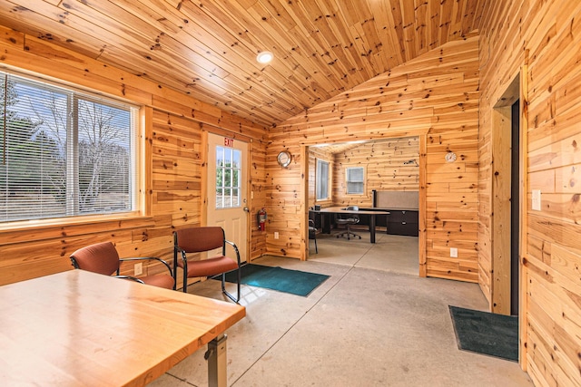 home office featuring wood walls, wooden ceiling, vaulted ceiling, and concrete flooring