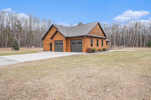 view of home's exterior featuring concrete driveway, a shingled roof, an attached garage, and a lawn