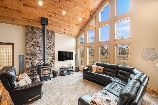 living area with a wood stove, high vaulted ceiling, recessed lighting, wooden ceiling, and baseboards