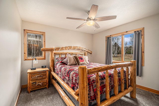 bedroom with carpet, baseboards, a textured ceiling, and a ceiling fan
