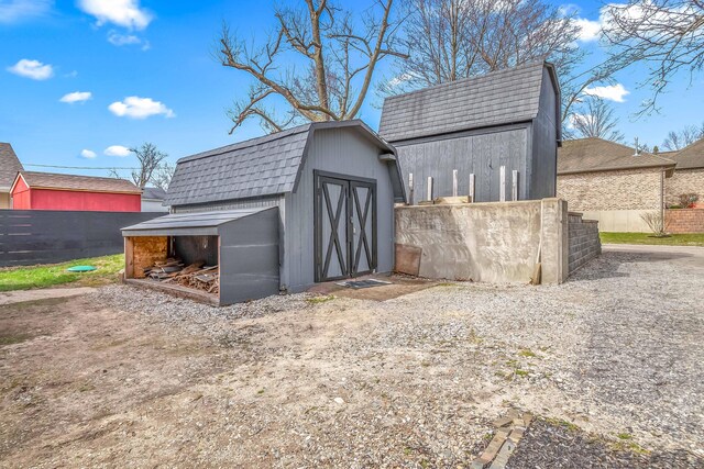 view of shed featuring fence