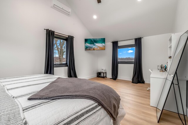bedroom featuring recessed lighting, a wall mounted AC, lofted ceiling, light wood finished floors, and baseboards
