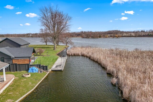 exterior space with a water view and a lawn