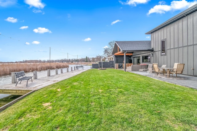 view of yard featuring a water view and a patio
