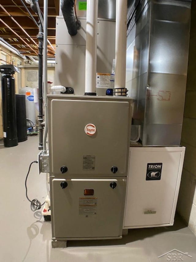 utility room featuring heating unit