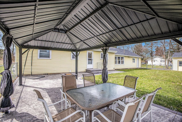 view of patio / terrace with a gazebo, outdoor dining area, and a fire pit