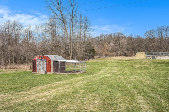 view of yard with an outbuilding, exterior structure, and a storage unit