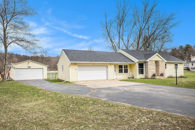 ranch-style house with a front yard, roof with shingles, an outdoor structure, and a detached garage