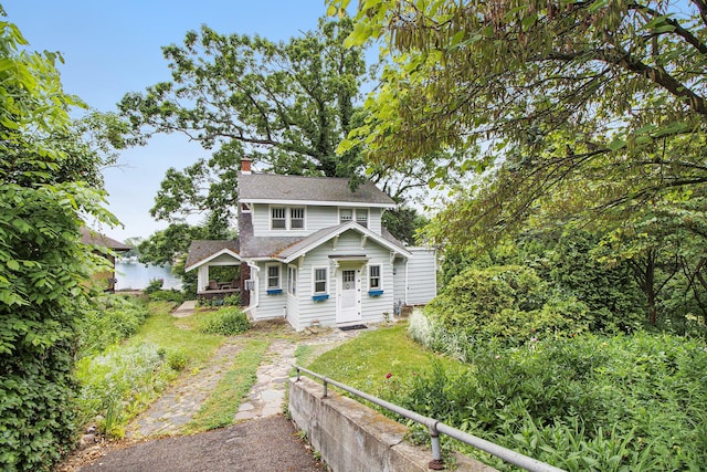 165 Honey Ln, Battle Creek, MI 49015 - back of property featuring a chimney and a shingled roof
