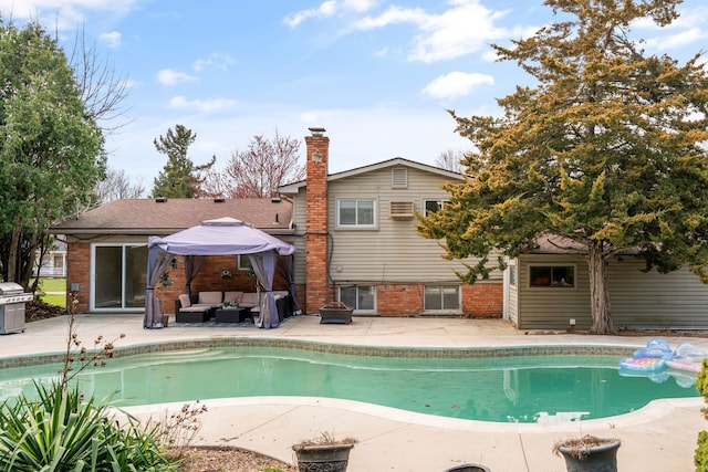 outdoor pool with outdoor lounge area and a patio area