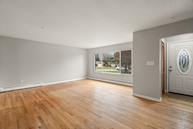 entrance foyer featuring baseboards, a baseboard radiator, a baseboard heating unit, and light wood finished floors