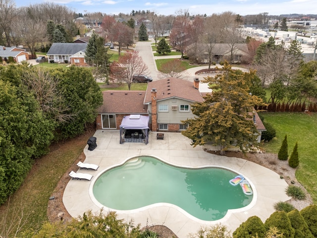 pool featuring a patio and a residential view