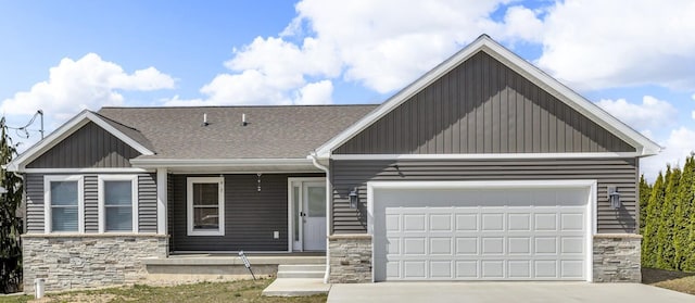 view of front of house featuring a porch, driveway, and stone siding