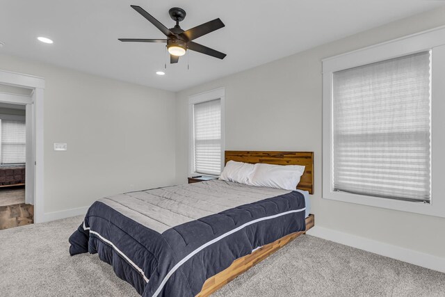 carpeted bedroom with baseboards, a ceiling fan, and recessed lighting