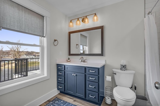 full bath with vanity, toilet, baseboards, curtained shower, and wood finished floors