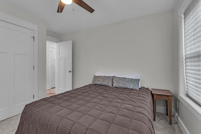 carpeted bedroom with baseboards and a ceiling fan