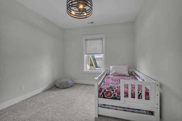carpeted bedroom with baseboards and visible vents