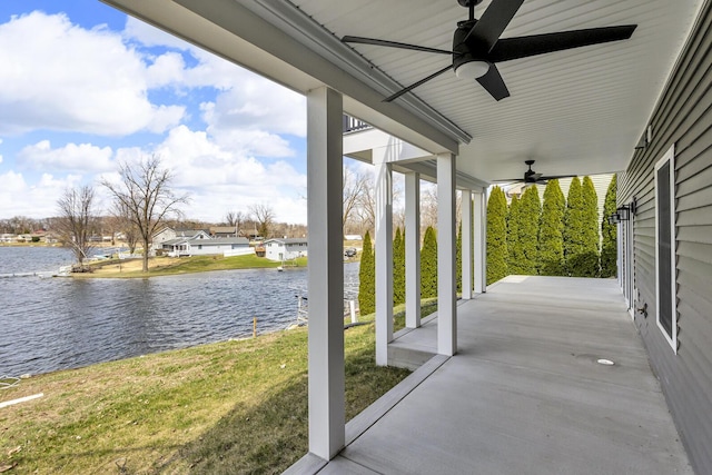 view of patio / terrace featuring covered porch, a water view, and ceiling fan
