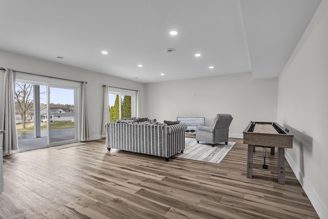 living area featuring baseboards, recessed lighting, and wood finished floors